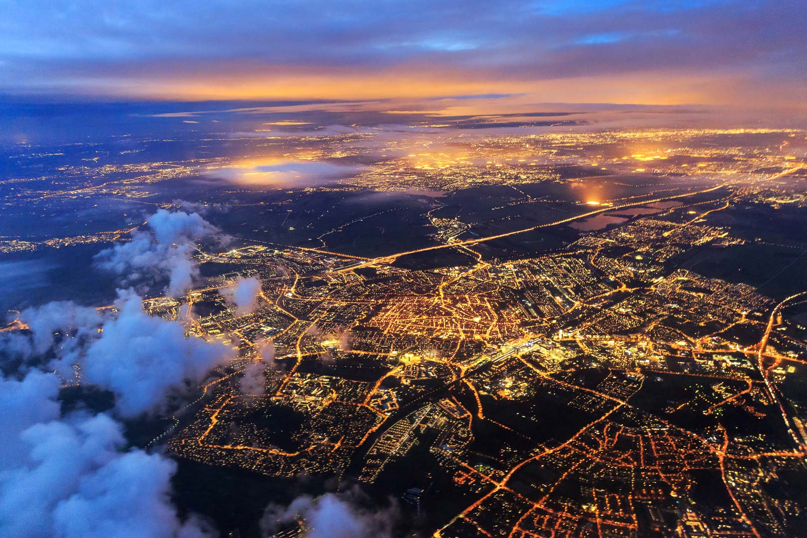airplane flying at night over a city