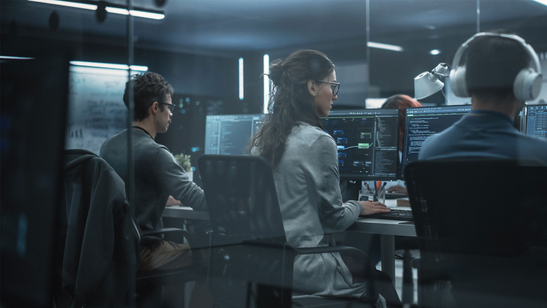 computer programmers working together in an office setting