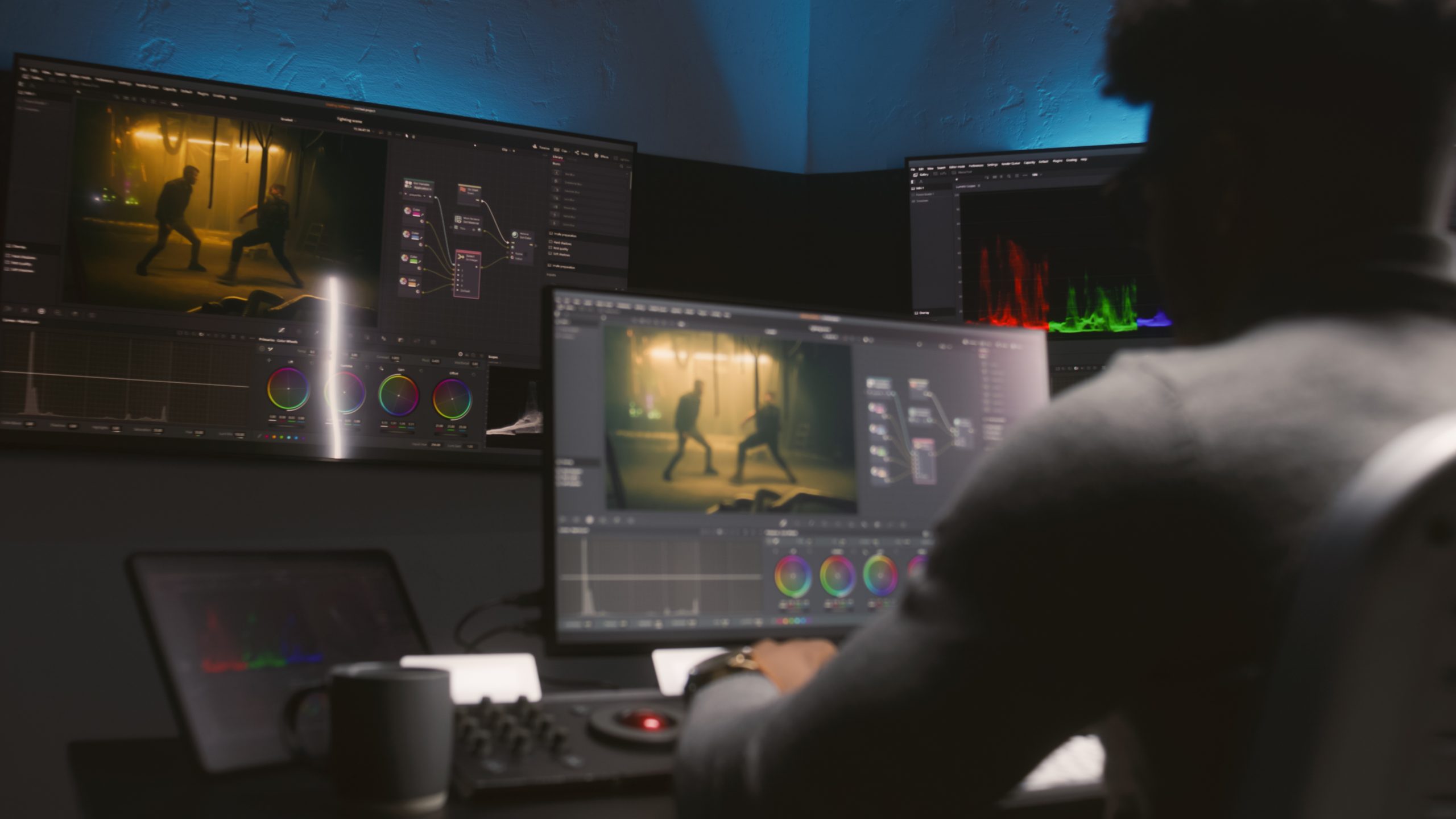 Colorist grading a feature film in a darkened post-production suite
